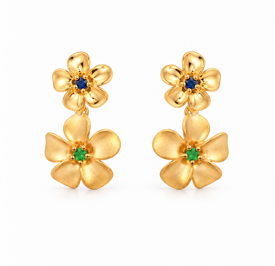 18ct yellow gold double frangipani stud earrings featuring polished flowers with blue sapphire centres and matte flowers with green garnet centres.