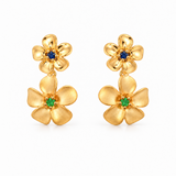 18ct yellow gold double frangipani stud earrings featuring polished flowers with blue sapphire centres and matte flowers with green garnet centres.