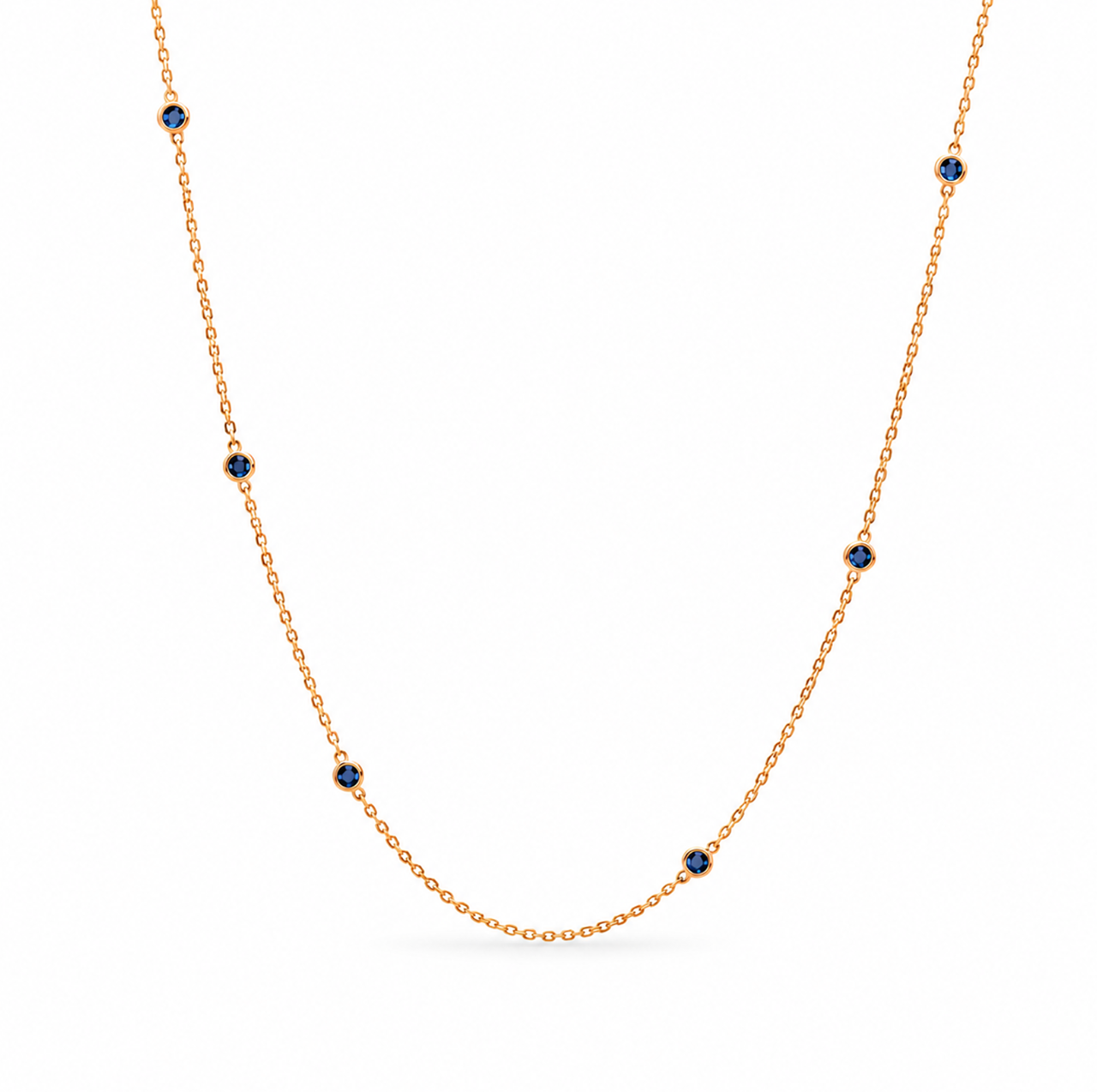 18ct yellow gold sapphire station necklet featuring seven round-cut blue sapphires in individual bezel settings along a fine 42cm trace chain.