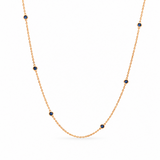 18ct yellow gold sapphire station necklet featuring seven round-cut blue sapphires in individual bezel settings along a fine 42cm trace chain.