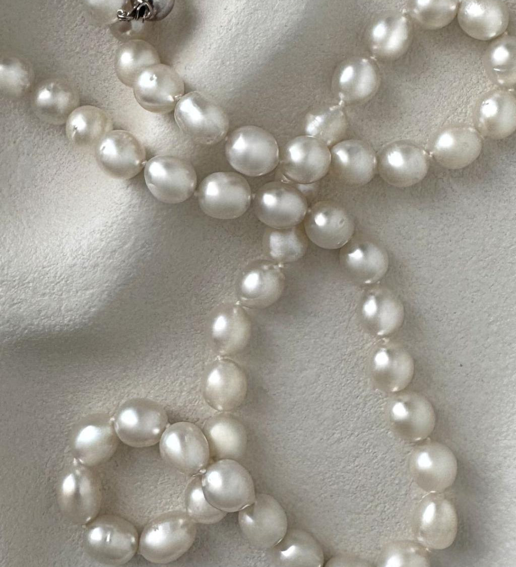 long South Sea pearl strand necklace with silver white oval pearls and sterling silver clasp