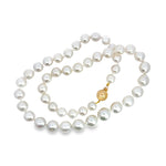 South Sea pearl strand with white near-round pearls and yellow gold clasp.