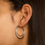 Sterling silver double hoop stud earrings with layered hoop design.