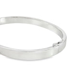 Sterling silver oval hinged bangle with slightly rounded flat profile.