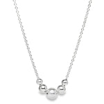 Sterling silver necklet with five graduated round beads on a fine trace link chain.