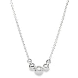 Sterling silver necklet with five graduated round beads on a fine trace link chain.