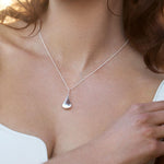 Sterling silver graduated puff raindrop pendant on box link chain.
