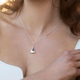 Sterling silver graduated puff raindrop pendant on box link chain.