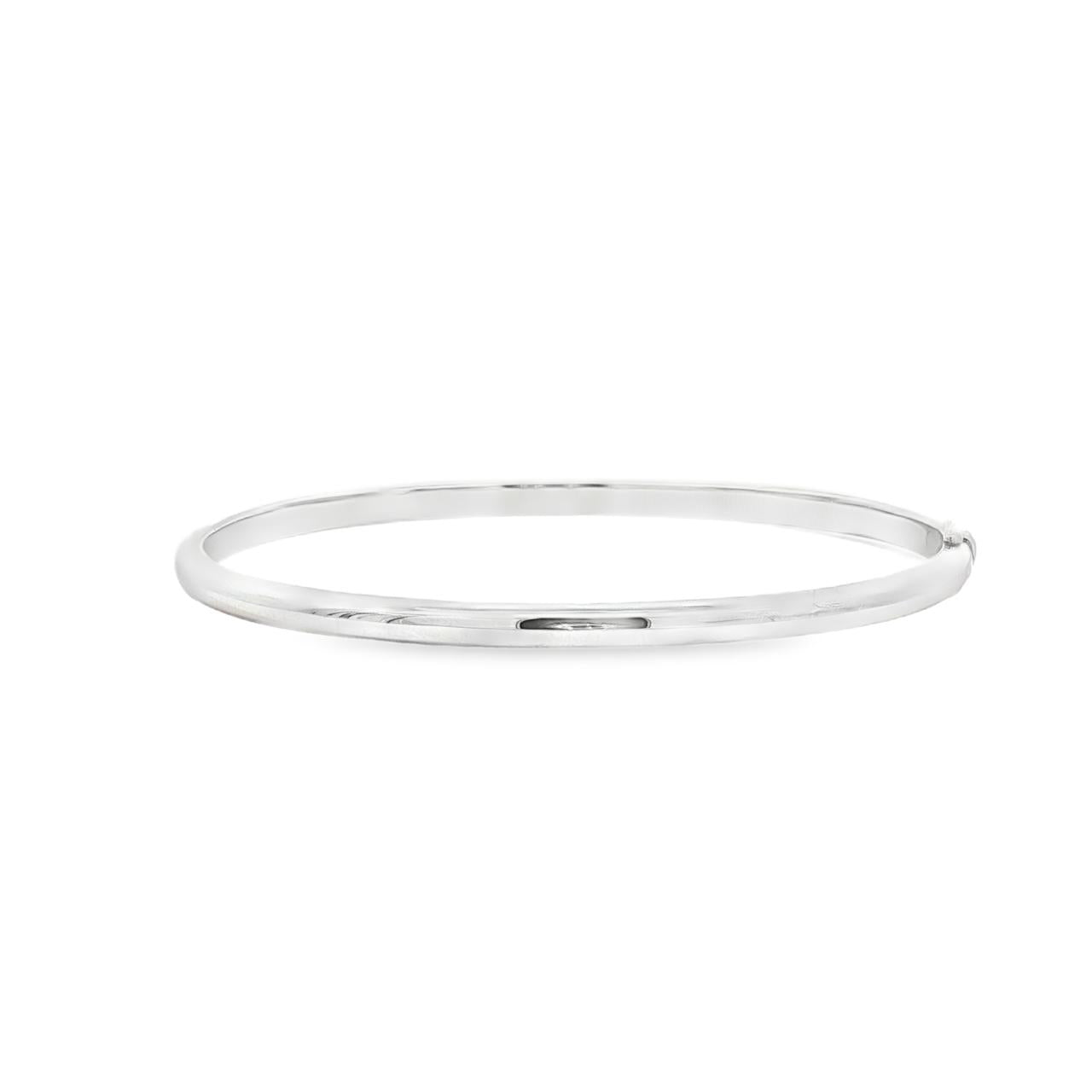 Sterling silver oval hinged bangle with high domed rounded profile.