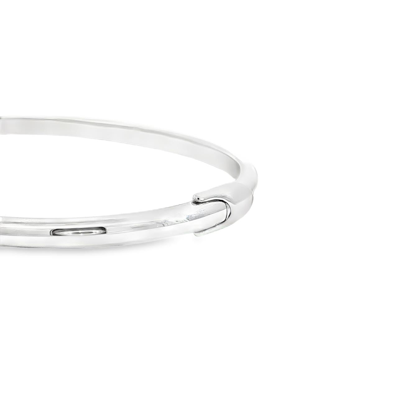 Sterling silver oval hinged bangle with high domed rounded profile.