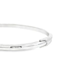 Sterling silver oval hinged bangle with high domed rounded profile.