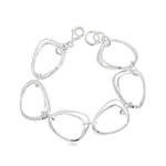 Sterling silver bracelet with open ovoid-shaped curved freeform links and lobster clasp, polished sculptural design.