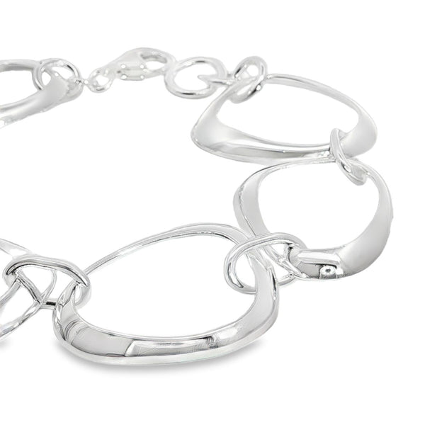 Sterling silver bracelet with open ovoid-shaped curved freeform links and lobster clasp, polished sculptural design.