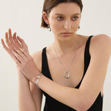 Sterling silver bracelet with open ovoid-shaped curved freeform links and lobster clasp, polished sculptural design.