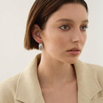 Sterling silver puff quilted hoop earrings with scalloped edge detailing.