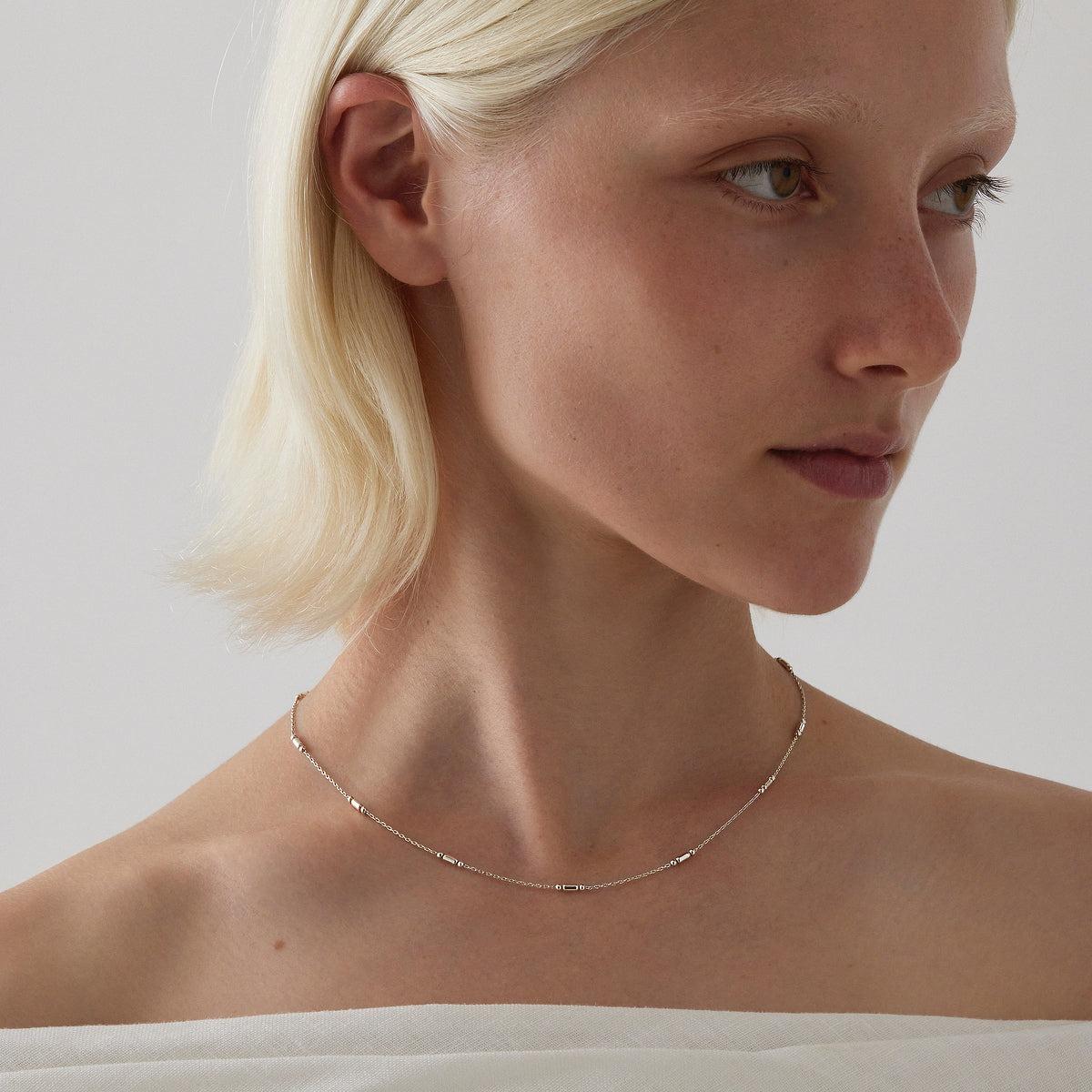 Sterling silver trace link chain with rod and bead station accents, 45cm with extender.