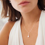 Sterling silver small graduated puff raindrop pendant on box link chain.