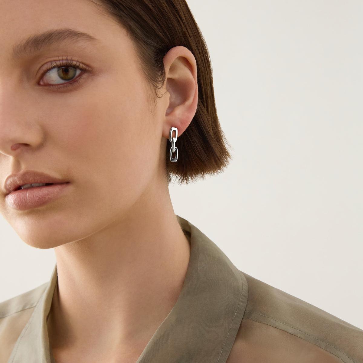 Sterling silver triple cushion-shaped open link drop stud earrings.