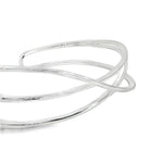 Sterling silver cuff bangle with open triple-strand curved crossover design, polished finish, 22mm wide, 60mm inner measurement.