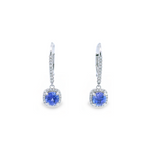 18ct white gold tanzanite and diamond cluster earrings featuring round-cut tanzanites with cushion-shaped diamond halos and articulated drops.