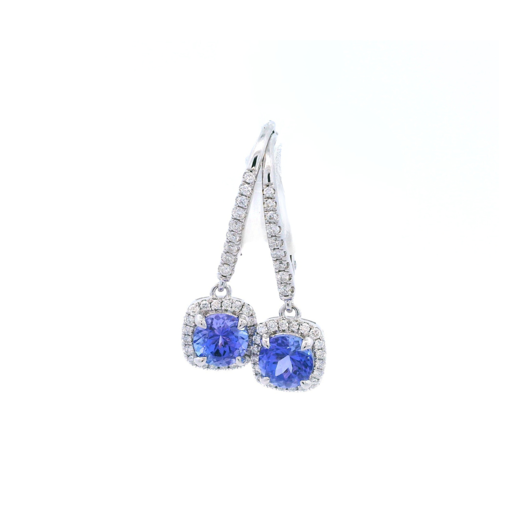 18ct white gold tanzanite and diamond cluster earrings featuring round-cut tanzanites with cushion-shaped diamond halos and articulated drops.