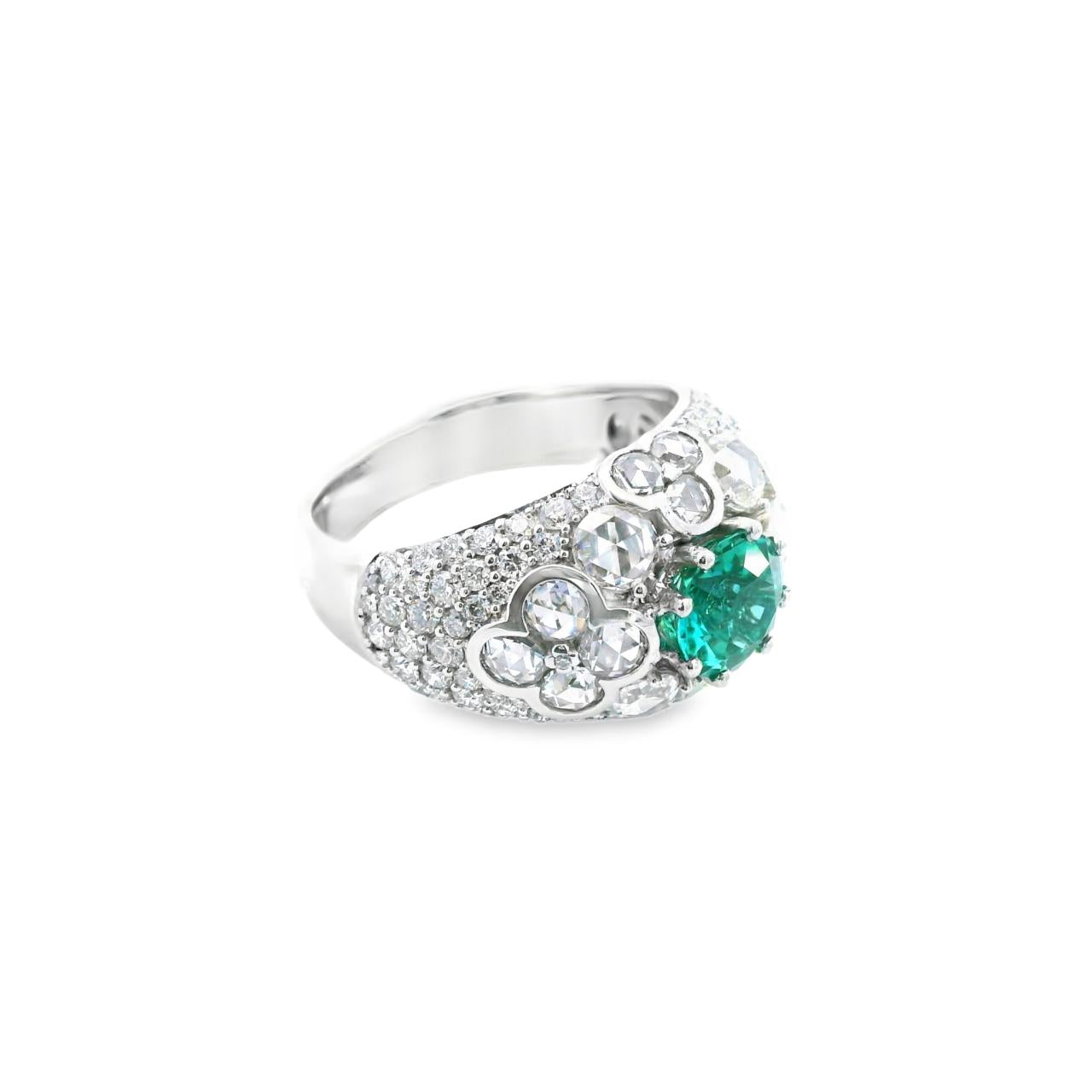 18ct white gold domed ring featuring a teal tourmaline with rose cut and round brilliant cut diamond floral clusters and pavé-set shoulders.