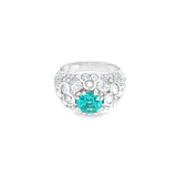 18ct white gold domed ring featuring a teal tourmaline with rose cut and round brilliant cut diamond floral clusters and pavé-set shoulders.