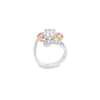 18ct white and rose gold ring featuring a round white diamond centre, two Argyle pink diamond side stones, and bead-set diamond shoulders in a loop design.