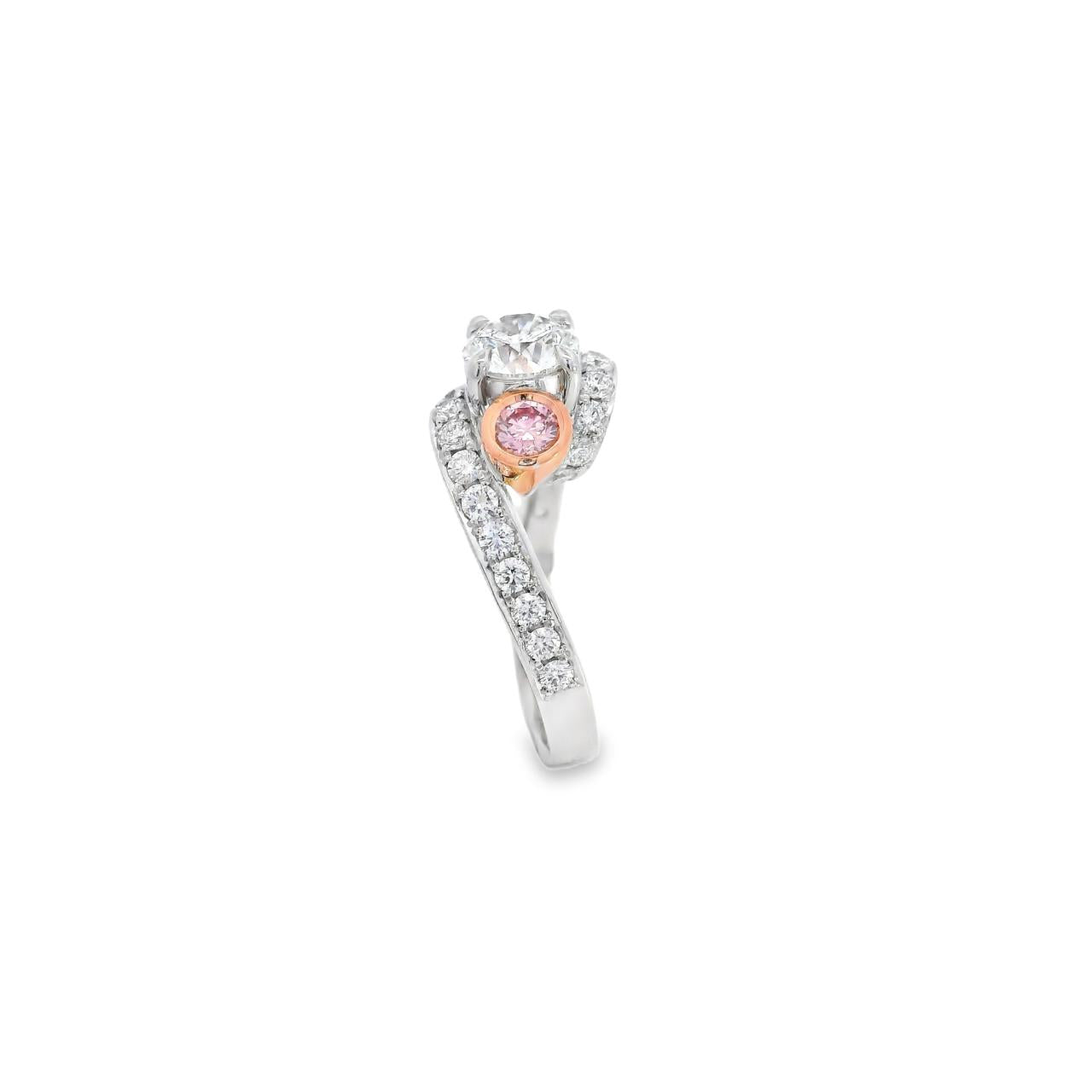 18ct white and rose gold ring featuring a round white diamond centre, two Argyle pink diamond side stones, and bead-set diamond shoulders in a loop design.