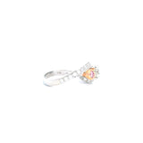 18ct white and rose gold ring featuring a round white diamond centre, two Argyle pink diamond side stones, and bead-set diamond shoulders in a loop design.