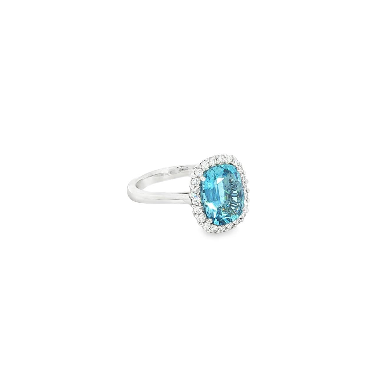 18ct white gold cushion-cut aquamarine ring with diamond halo.