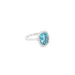 18ct white gold cushion-cut aquamarine ring with diamond halo.