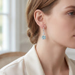 18ct white gold aquamarine and diamond cluster drop earrings with articulated circular and cushion clusters.