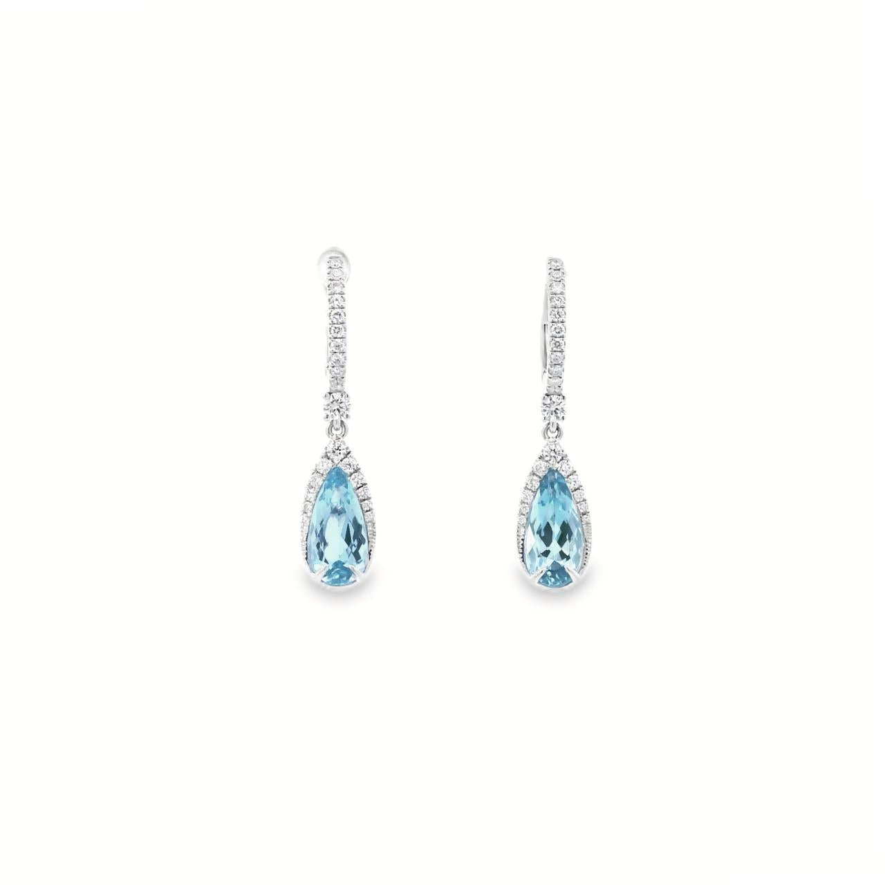 18ct white gold aquamarine and diamond drop earrings with pear cut aquamarines and claw set diamonds.