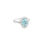 18ct white gold aquamarine and diamond halo ring with oval aquamarine and split diamond shoulders.