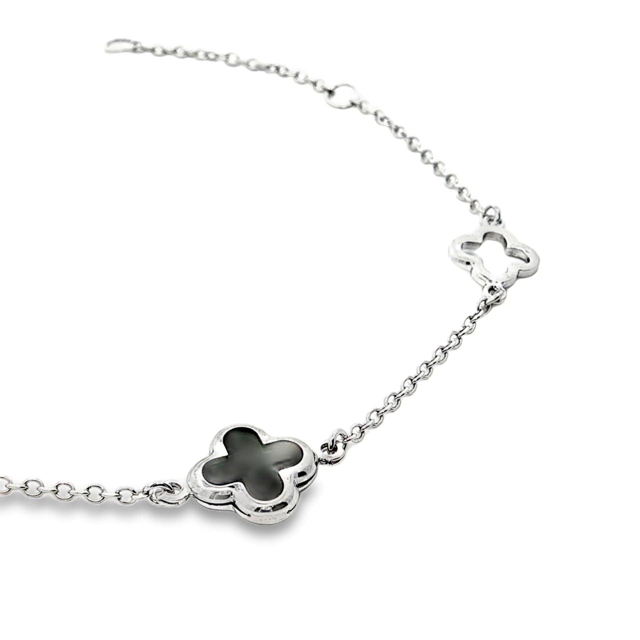 9ct white gold trace link bracelet with black clover centre and open clover details.