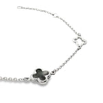 9ct white gold trace link bracelet with black clover centre and open clover details.