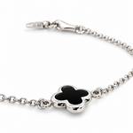 9ct white gold trace link bracelet with small black clover centre.