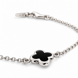 9ct white gold trace link bracelet with small black clover centre.