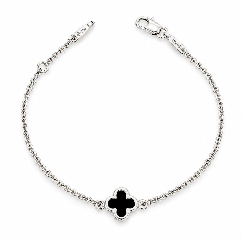9ct white gold trace link bracelet with small black clover centre.