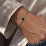 9ct white gold trace link bracelet with small black clover centre.