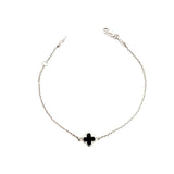 9ct white gold trace link bracelet with small black clover centre.
