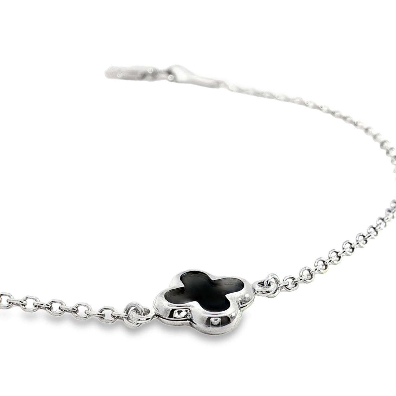 9ct white gold trace link bracelet with small black clover centre.