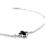 9ct white gold trace link bracelet with small black clover centre.