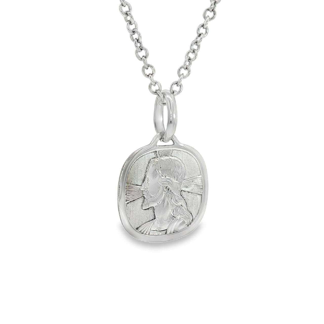 18ct white gold cushion shaped Jesus religious medallion with engraved halo detail.