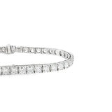 18ct white gold diamond tennis bracelet with round brilliant cut diamonds in four-claw settings.
