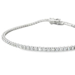 18ct white gold diamond tennis bracelet with round brilliant cut diamonds in four-claw settings.