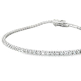 18ct white gold diamond tennis bracelet with round brilliant cut diamonds in four-claw settings.