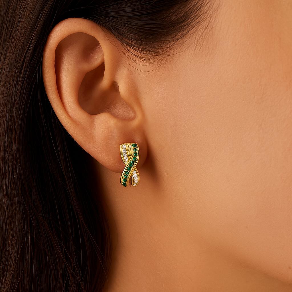 18ct white gold crossover earrings with emerald and diamond rows.