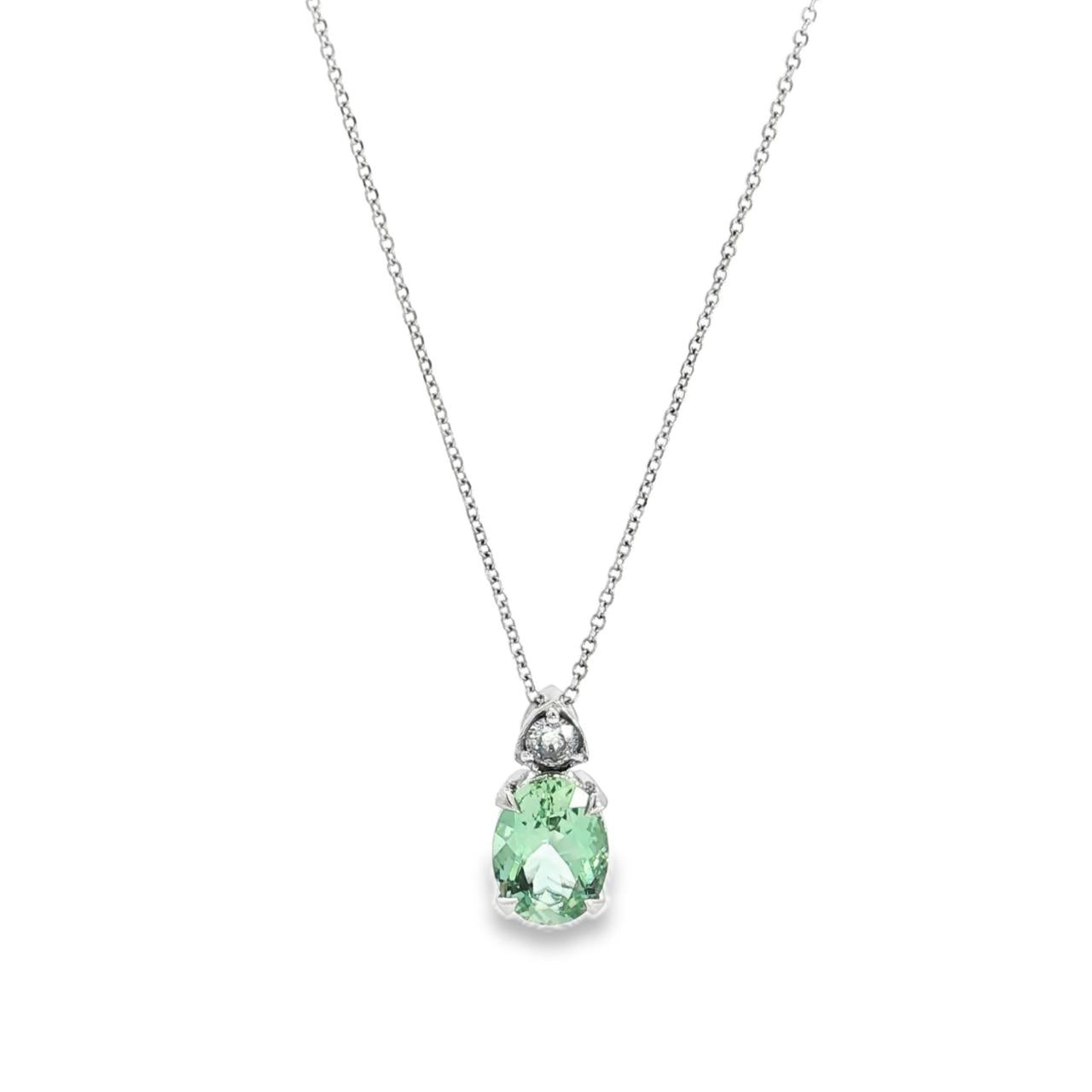 9ct white gold green beryl and diamond pendant with oval green beryl and triangular diamond accent.
